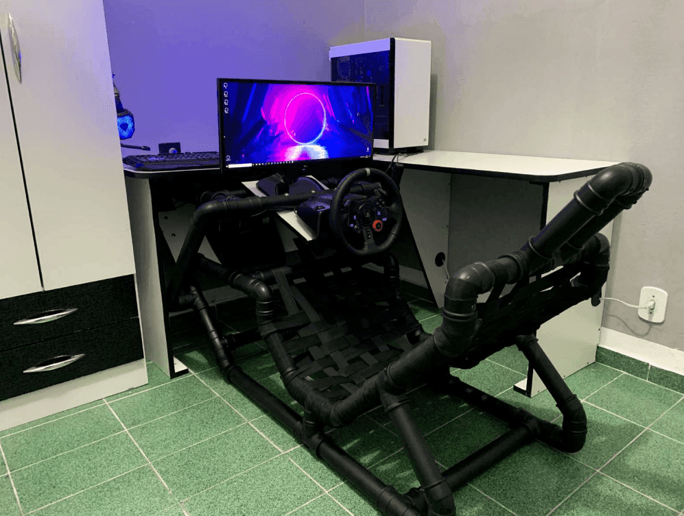Wide view of the finished cockpit and full sim racing setup at the desk