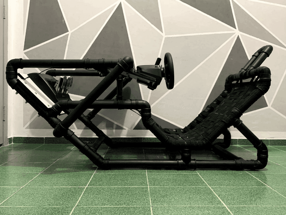 Side view of the finished black PVC cockpit with woven strap seat and steering wheel mount