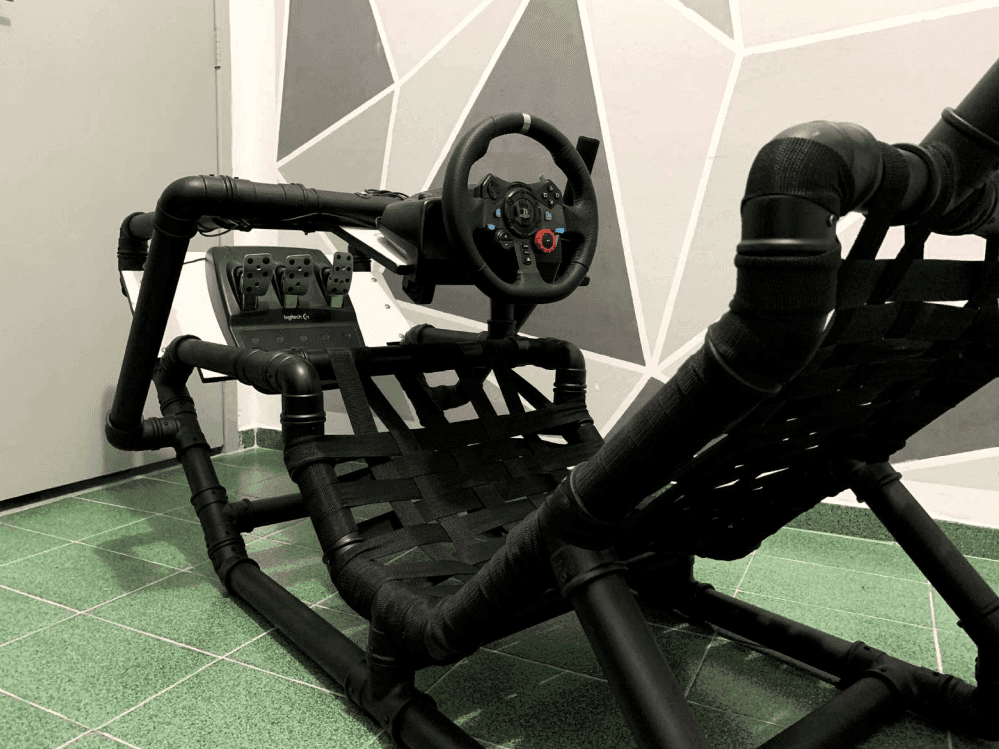 Front three-quarter view of the cockpit with a Logitech G29 wheel and pedals mounted