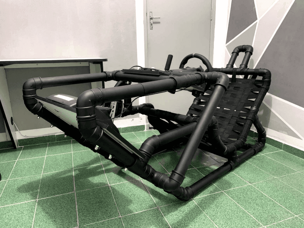 Rear view of the black PVC cockpit frame showing the seat and monitor mount structure